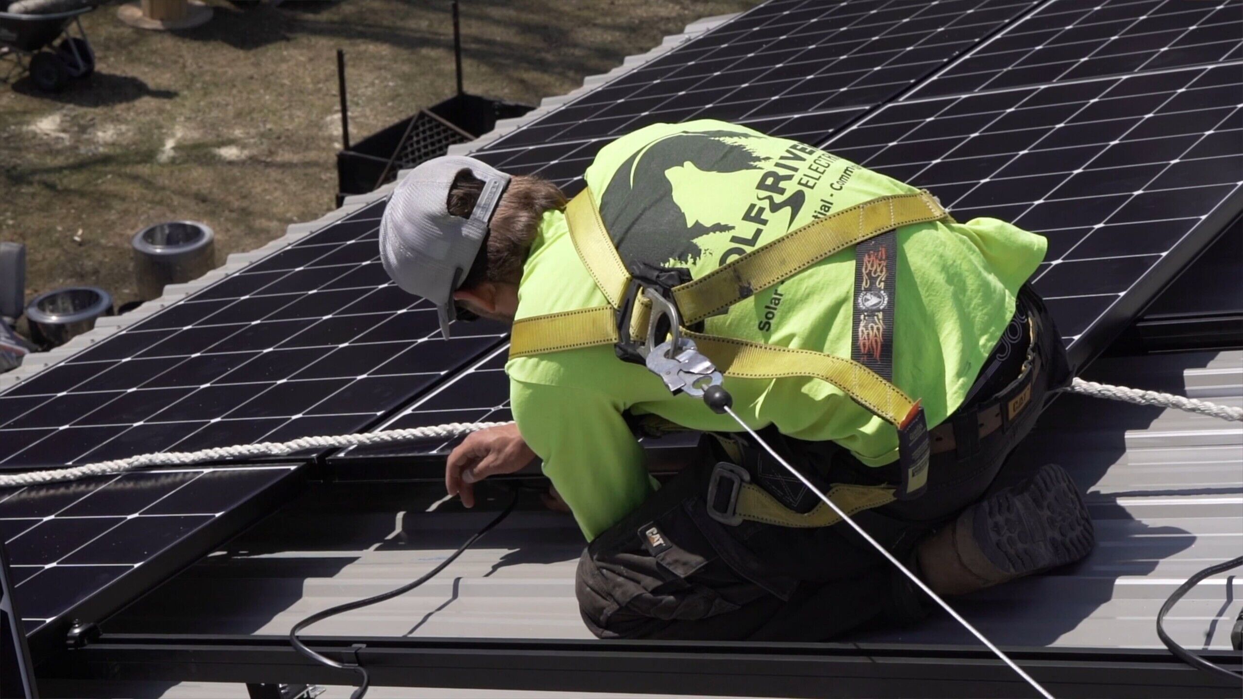 Professional solar panel installation by Wolf River Electric technician on a residential roof in Minnesota.
