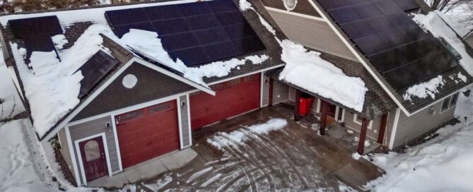 House with solar panels on the roof covered in snow in Madison WI