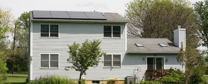 Two-story house with solar panels installed on the roof in Rochester