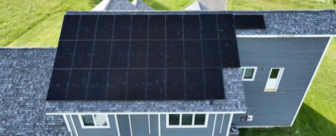 Aerial view of a house with solar panels installed on the roof in Maple Grove