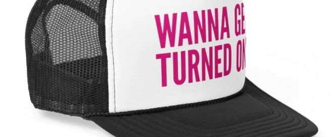 Wolf River Electric branded trucker hat featuring the bold slogan 'Wanna Get Turned On,' showcasing clean energy with style.