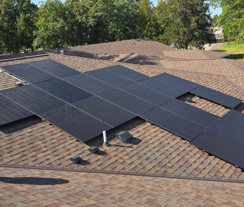 Low-profile rooftop solar panel installation on pitched shingle roof Low-profile rooftop solar panel installation on pitched shingle roof