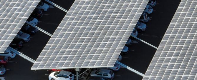 Commercial solar carport canopy with solar panels covering parking lot