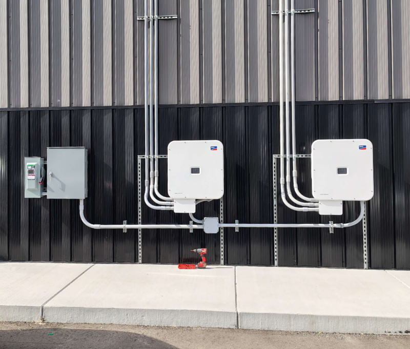 Commercial solar battery storage system mounted on industrial facility exterior Commercial solar battery storage system mounted on industrial facility exterior