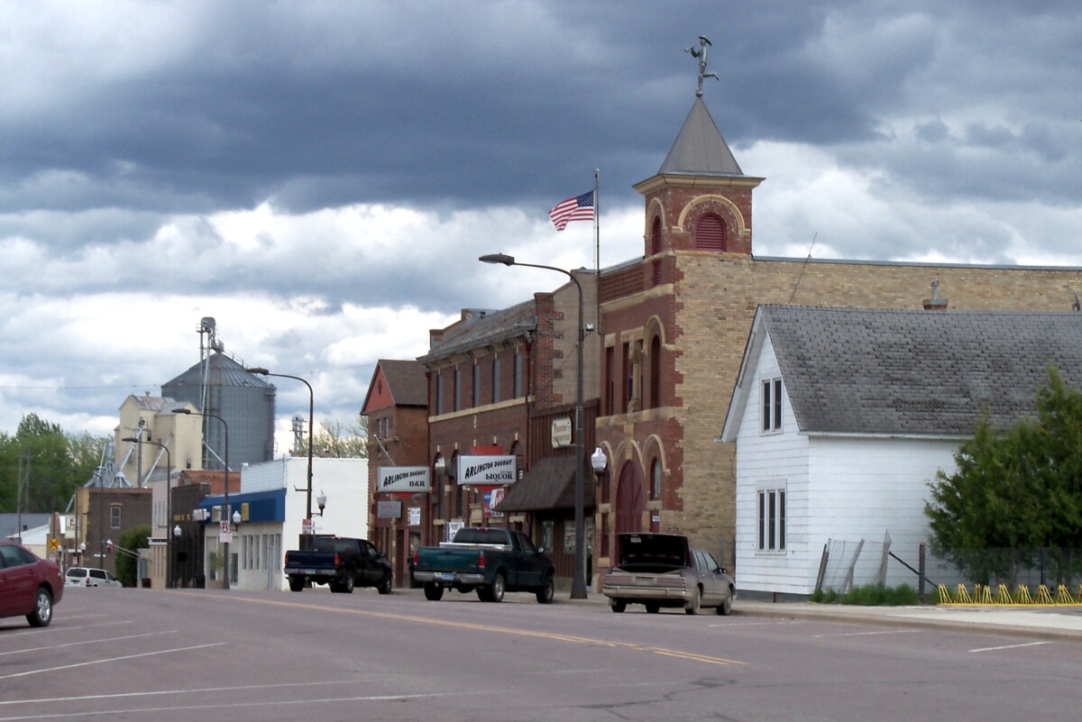 Businesses and cars parked on a street in Arlington, Minnesota during an overcast day. Businesses and cars parked on a street in Arlington, Minnesota during an overcast day.