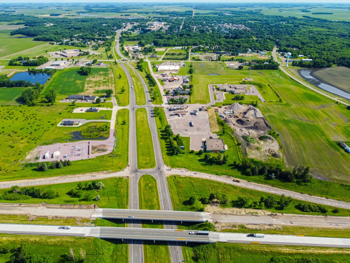 An aerial shot of Blue Earth, Minnesota showing green fields, highways, and structures.