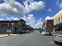 Businesses on Lewis Avenue in Watertown, Minnesota during the day.