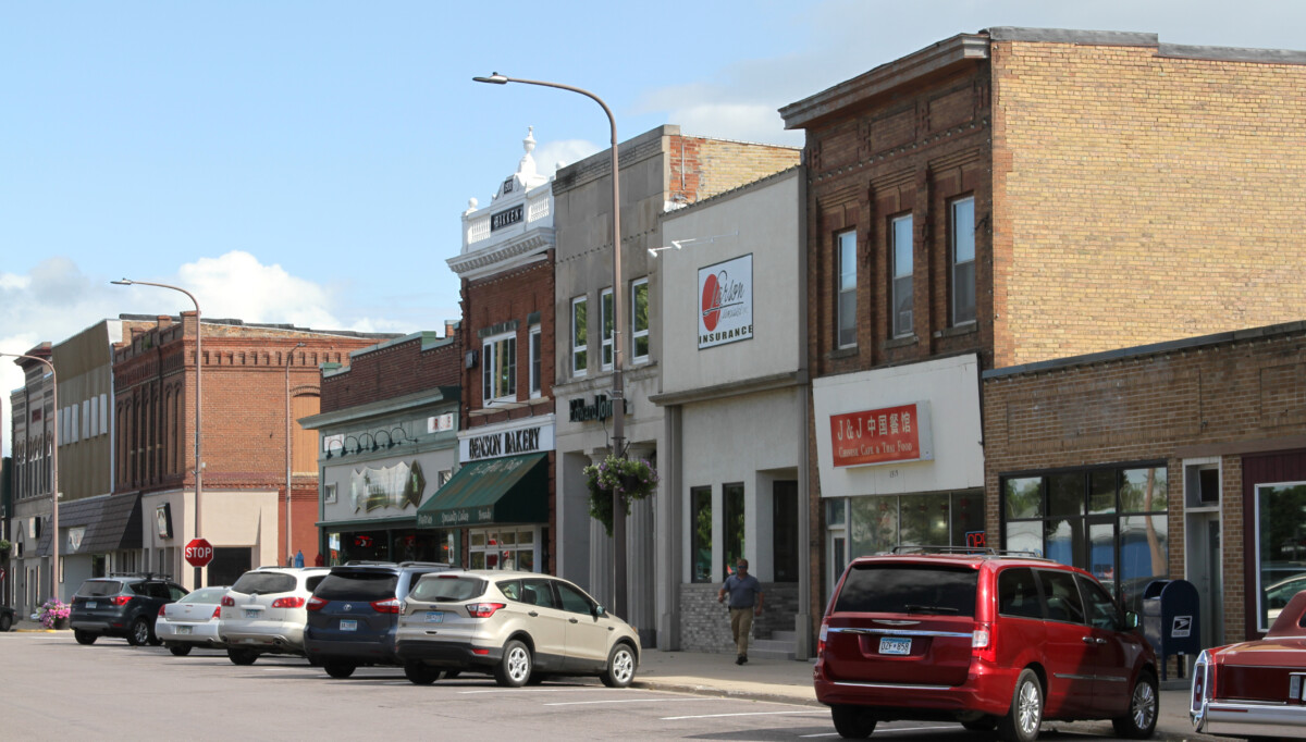 Businesses and cars parked on a street on Pacific Avenue in Benson, Minnesota. Businesses and cars parked on a street on Pacific Avenue in Benson, Minnesota.