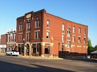 Corner shot of the Q. Berg Hotel in Sleepy Eye, MN during the day.