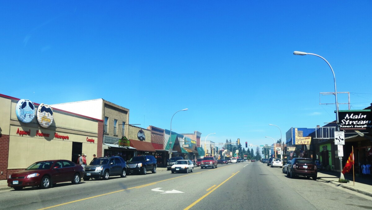 A business lined street in Cass County, Minnesota during the day with a clear blue sky in the background.