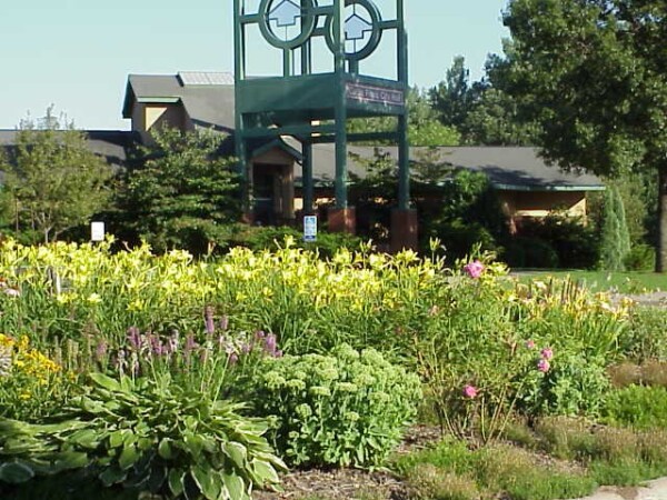 Circle Pines City Hall clock‑tower landmark surrounded by lush summer landscaping in Circle Pines, Minnesota civic plaza Circle Pines City Hall clock‑tower landmark surrounded by lush summer landscaping in Circle Pines, Minnesota civic plaza