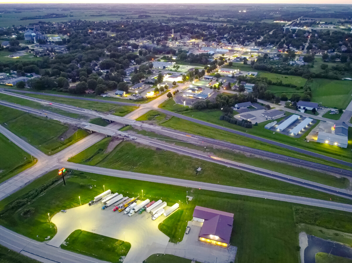 An aerial shot of Kasson, Minnesota showing highways, green grass, trees, and structures.
