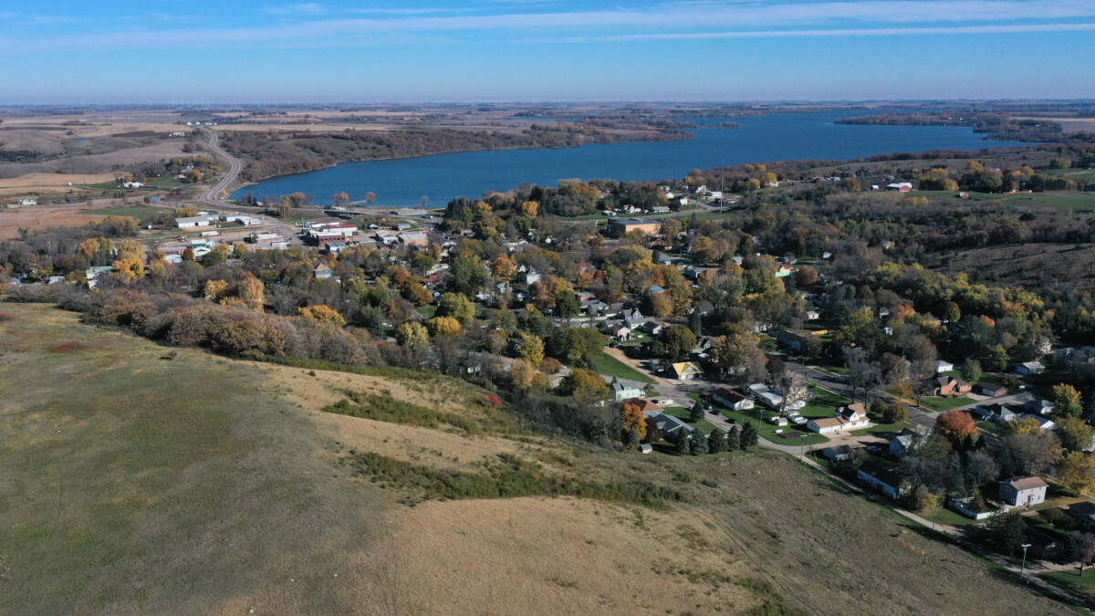 An aerial shot of Lake Benton, Minnesota and surrounding homes and trees viewed from Hole in the Mountain Prairie.