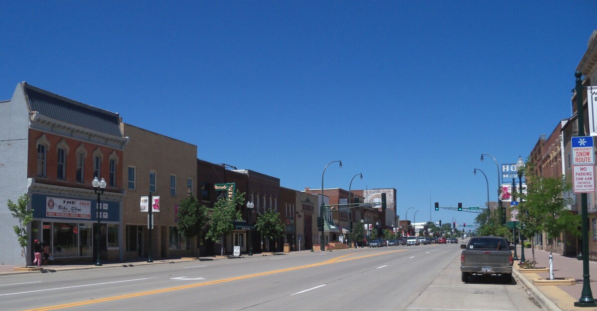 A business lined street with clear blue sky above in Marshall, Minnesota.