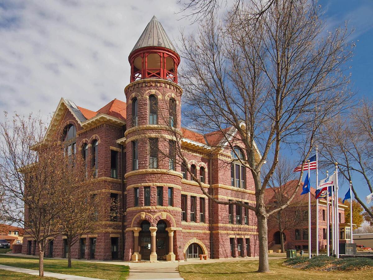 Shot of the Rock County Courthouse with flags and trees out front during the day. Shot of the Rock County Courthouse with flags and trees out front during the day.