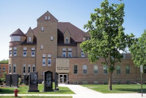 Historic Yellow Medicine County Courthouse in Granite Falls, MN: two‑story light‑brick Romanesque Revival building with central tower and turrets. Historic Yellow Medicine County Courthouse in Granite Falls, MN: two‑story light‑brick Romanesque Revival building with central tower and turrets.