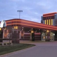 Running Aces Casino & Racetrack entrance and grandstand at sunset in Columbus, Minnesota, showcasing premier harness racing and gaming venue Running Aces Casino & Racetrack entrance and grandstand at sunset in Columbus, Minnesota, showcasing premier harness racing and gaming venue
