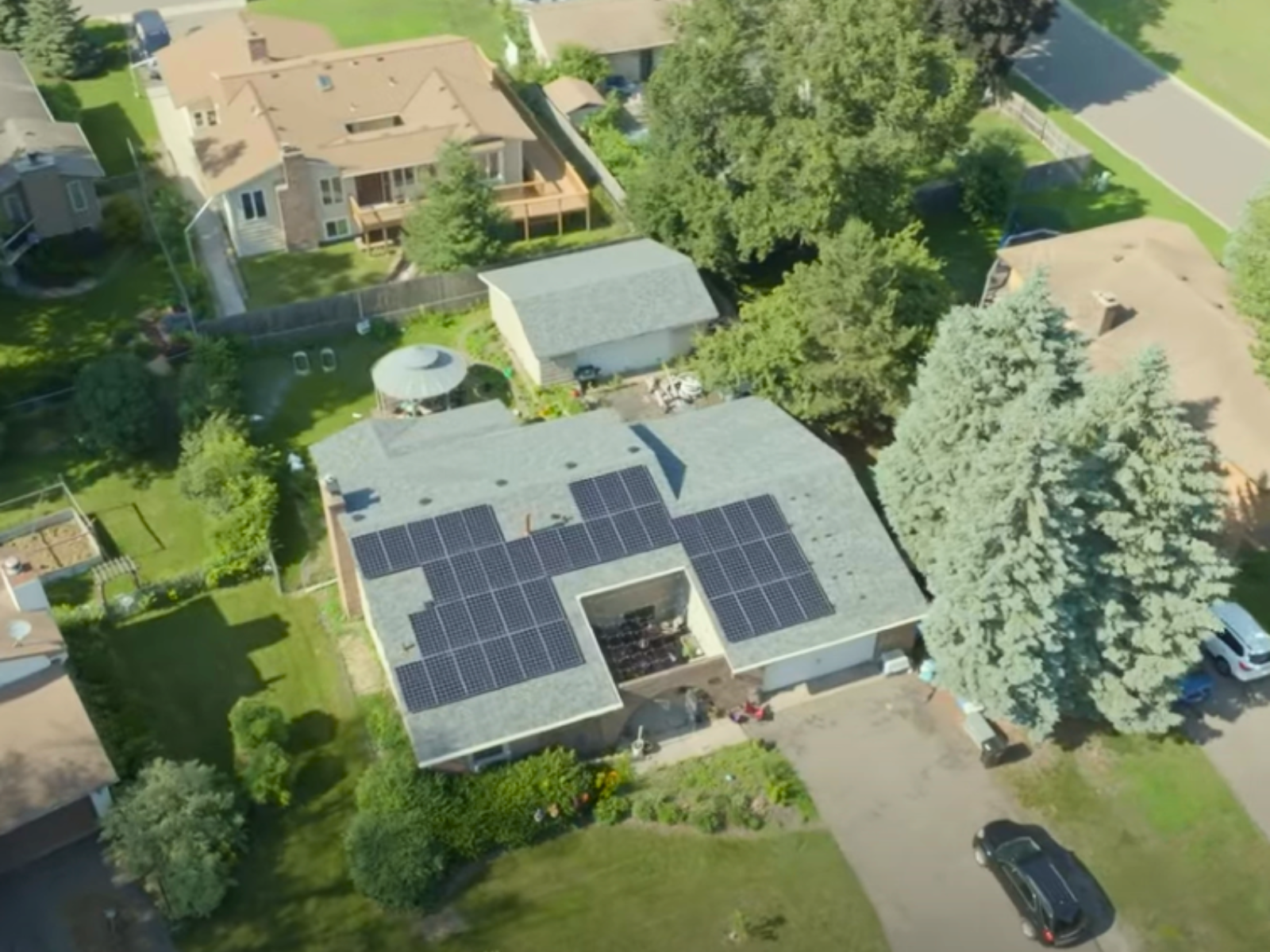Aerial shot of residential solar system installed by Wolf River Electric in a suburban neighborhood