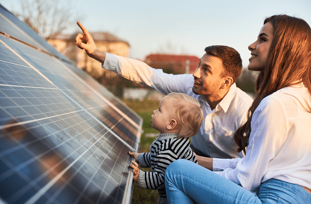 financing-options Solar panel installation with a family outdoors, promoting renewable energy solutions from Wolf River Electric.