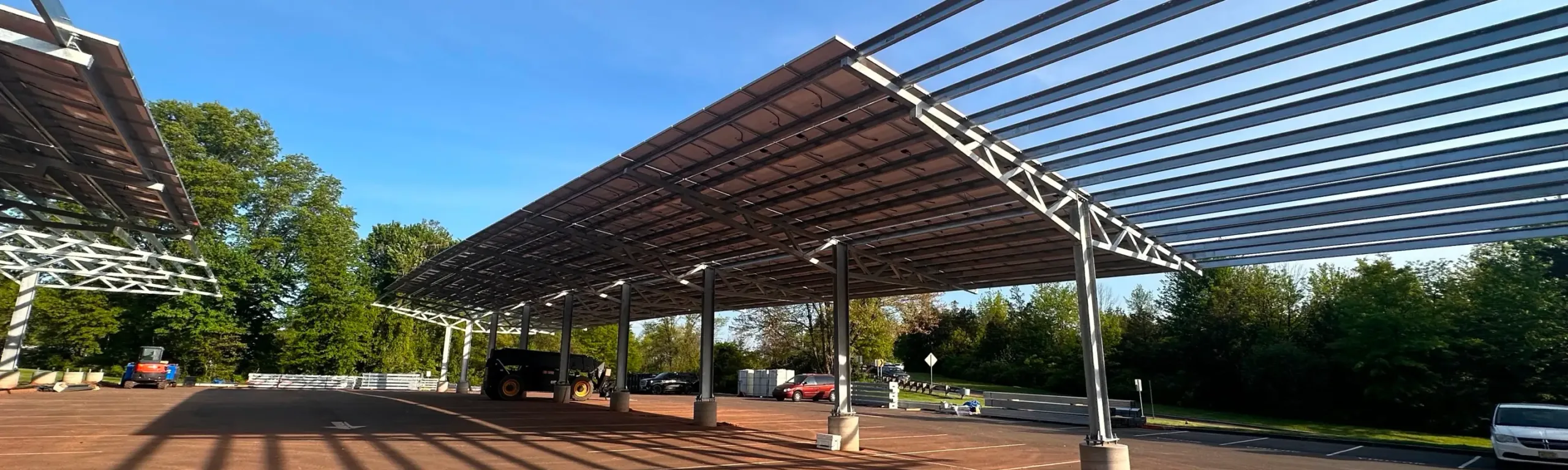 Solar canopies covering rows of parking spaces.
