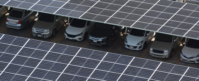 Commercial solar carports installed over a parking lot providing shade and renewable energy for vehicles, Wolf River Electric