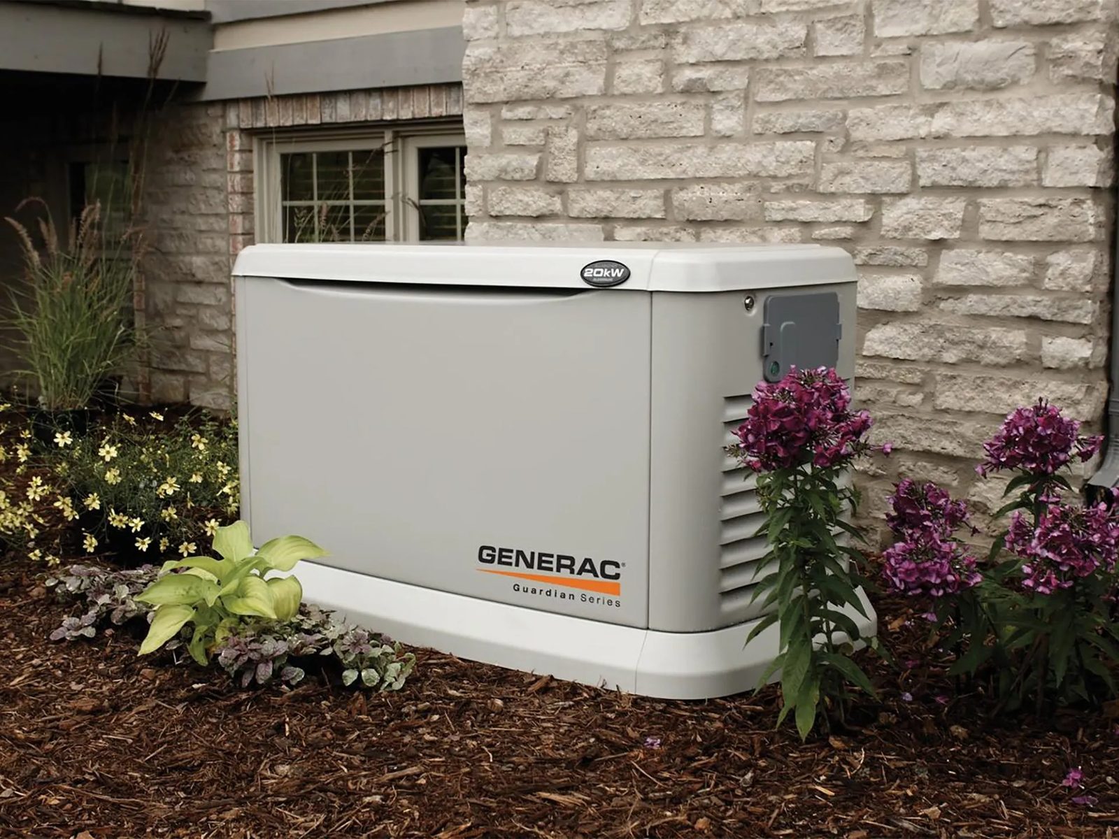 Generac Guardian 20 kW standby generator beside a stone home