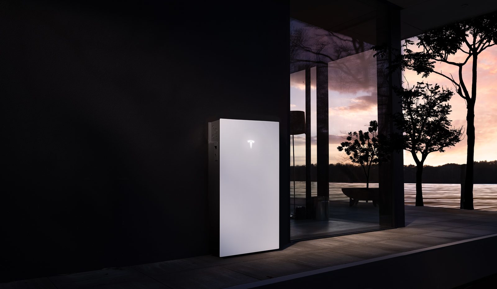 Tesla Powerwall 3 mounted on an exterior home wall at dusk