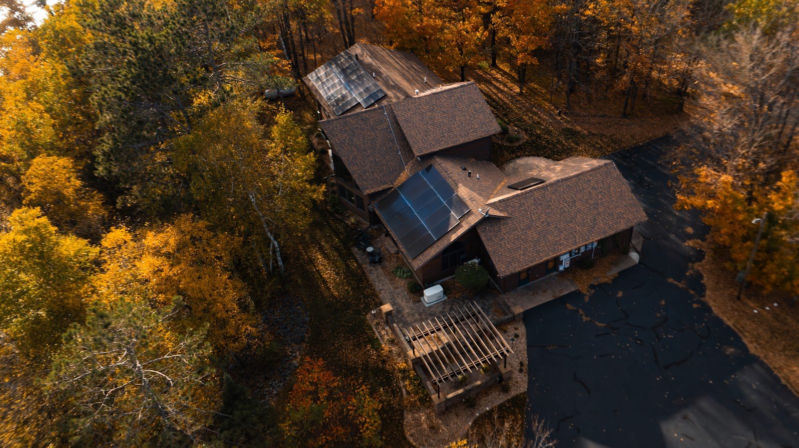 Aerial fall homes solar panels, installed by Wolf River Electric
