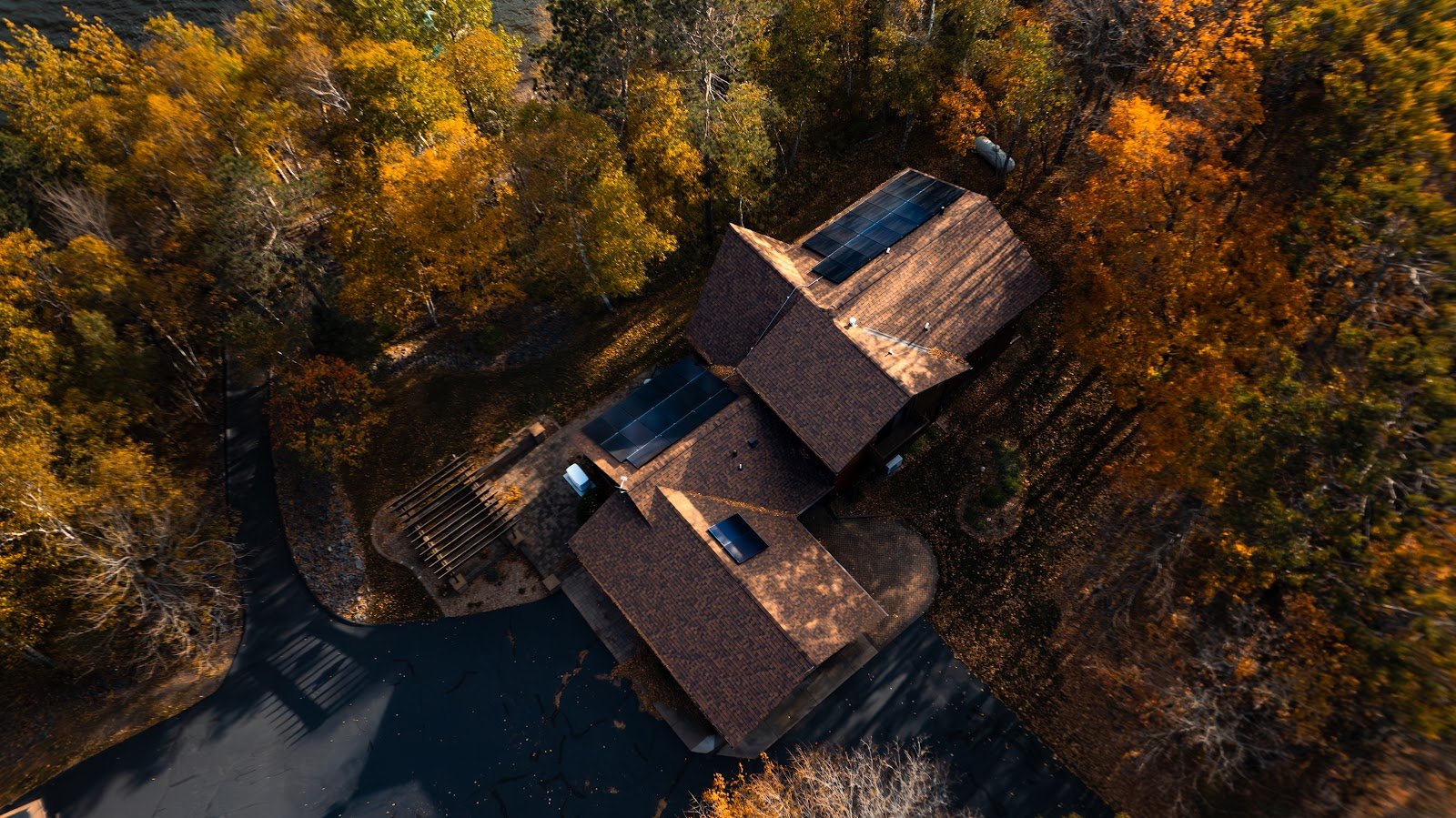 Aerial home fall trees with rooftop solar, installed by Wolf River Electric