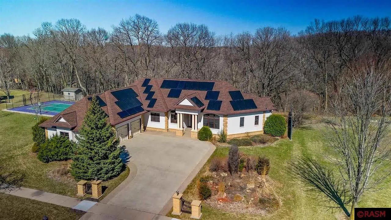 Aerial home in woods with rooftop solar, installed by Wolf River Electric