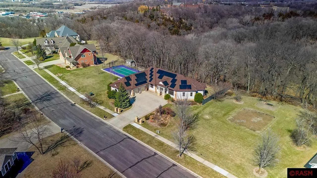 Aerial home rural road with rooftop solar, installed by Wolf River Electric