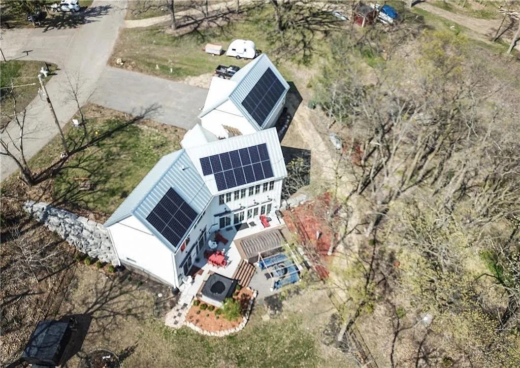 Aerial white home with solar panels, installed by Wolf River Electric