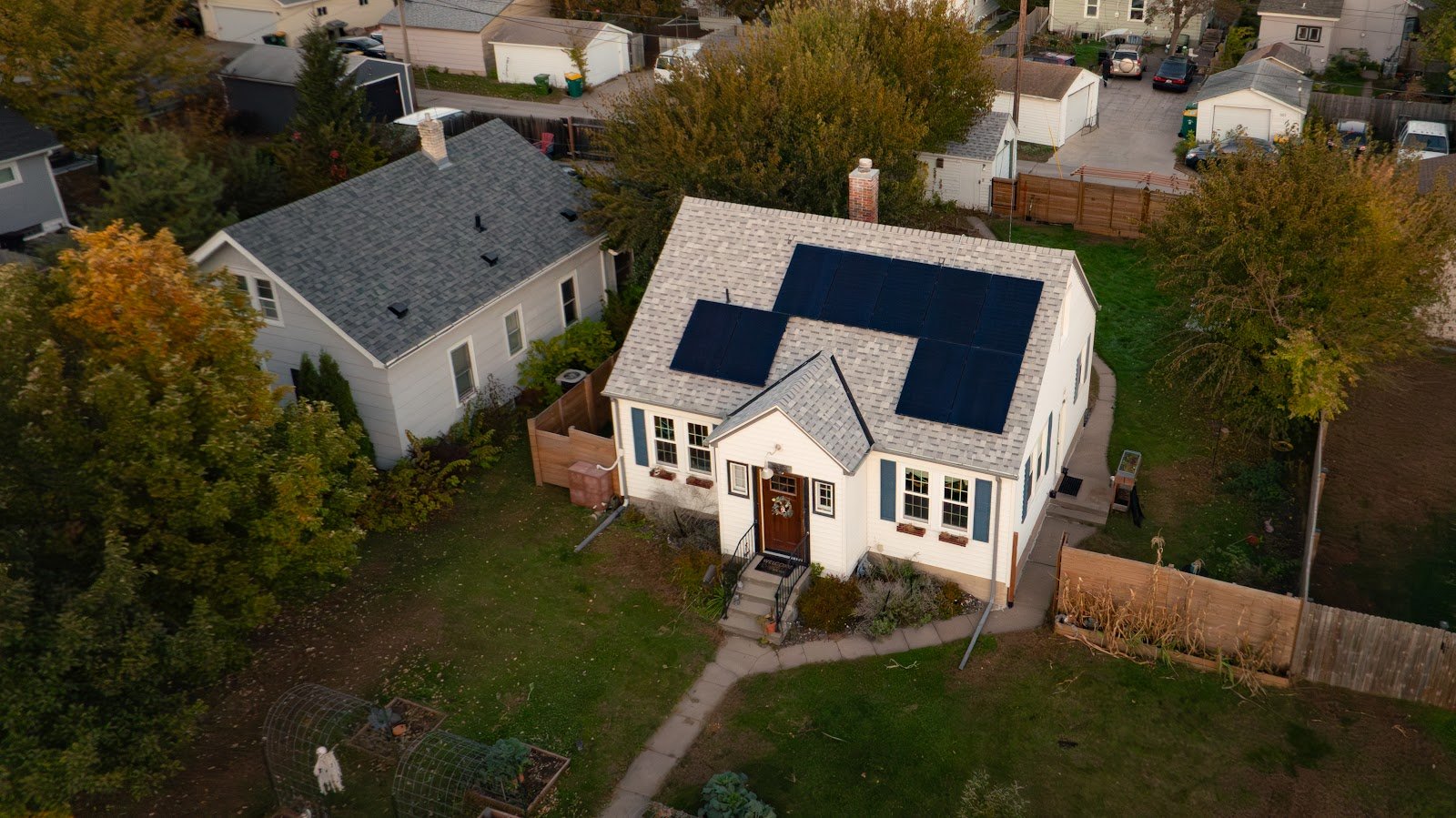 Aerial white house with solar panels, installed by Wolf River Electric