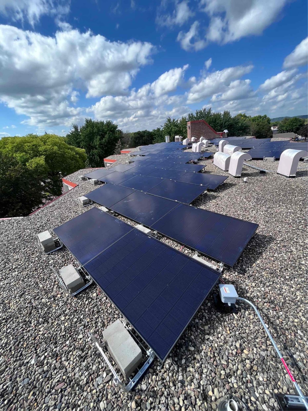 Ballasted solar array on a commercial rooftop, installed by Wolf River Electric