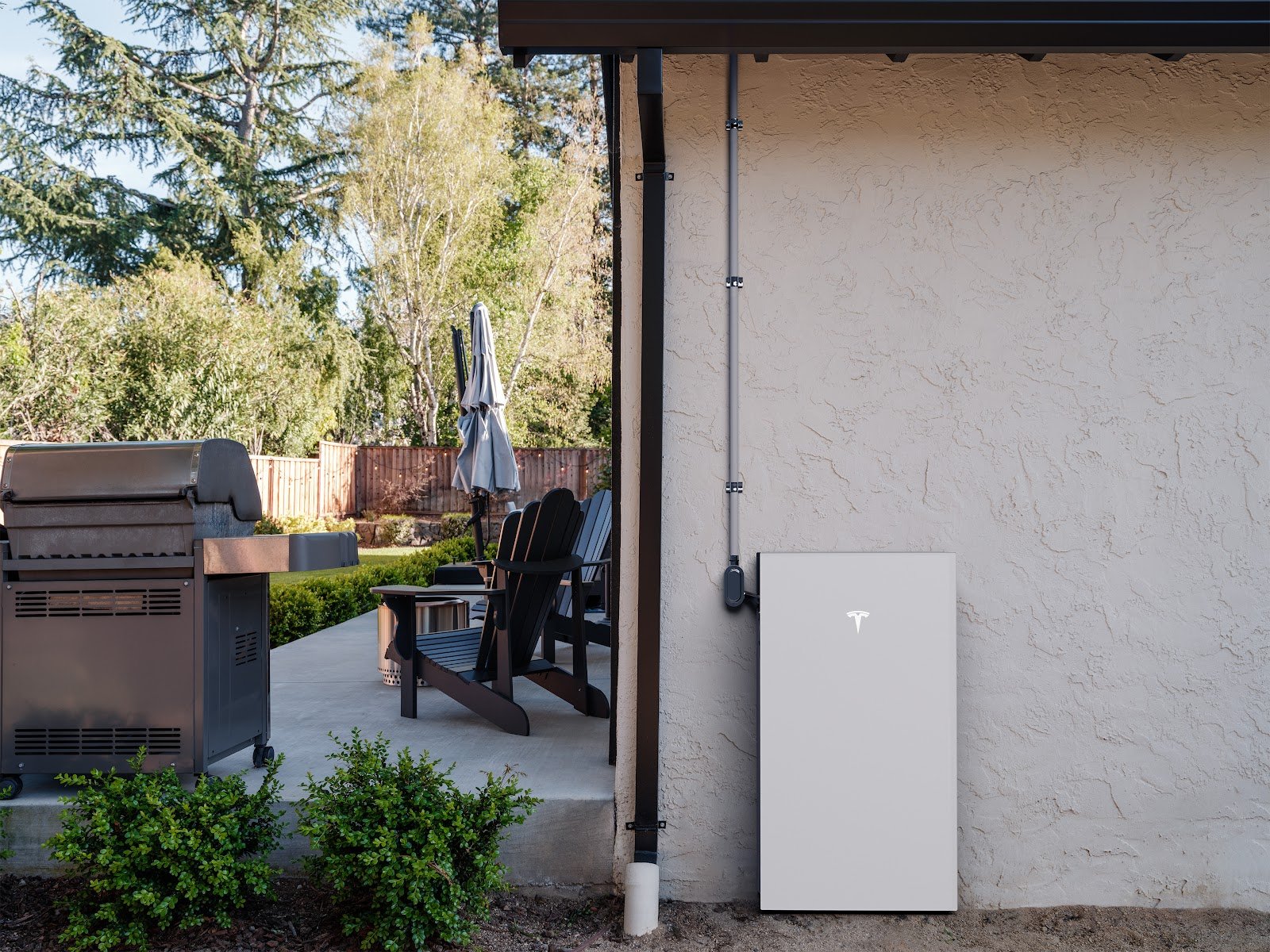 Battery on house wall by patio, installed by Wolf River Electric