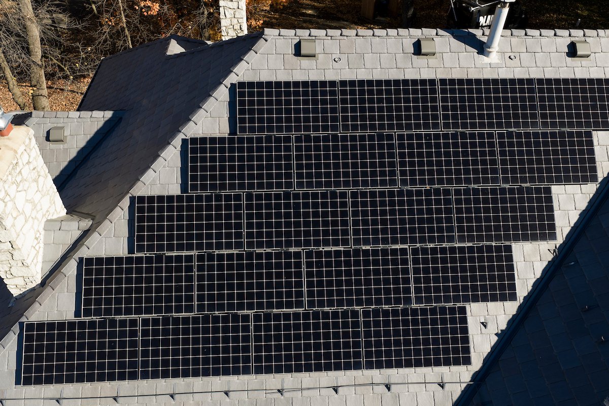 Black solar panels on a slate roof seen from above, installed by Wolf River Electric