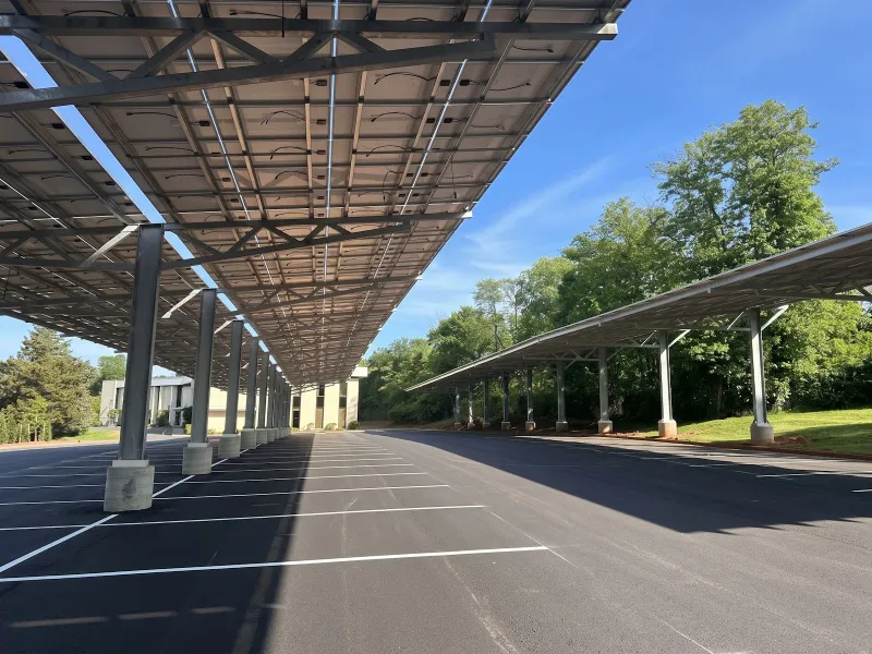 View under a solar carport canopy over parking spaces, installed by Wolf River Electric