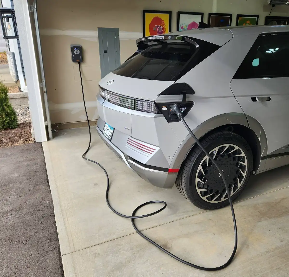 Electric car charging in garage, installed by Wolf River Electric