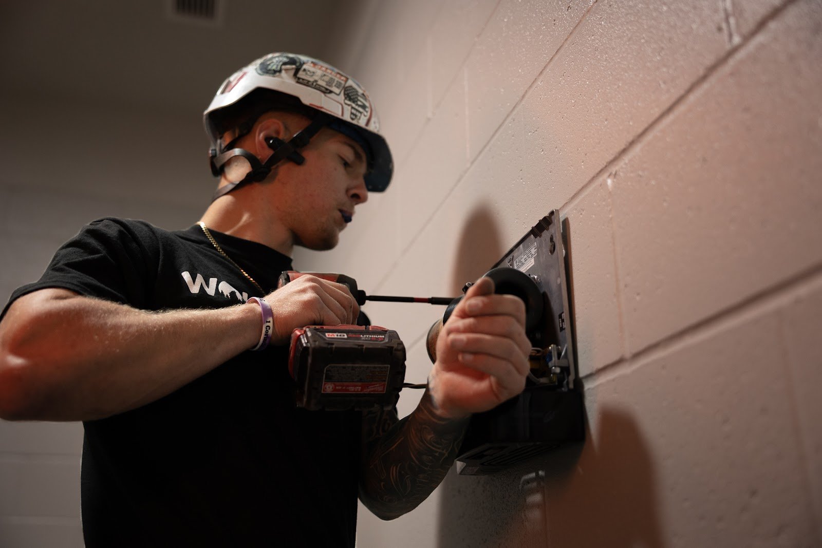 Wolf River Electric electrician hard hat drilling
