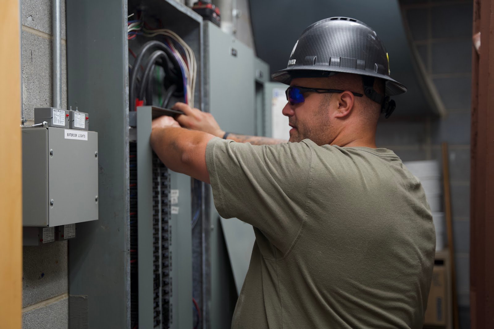 Wolf River Electric electrician hard hat working in panel