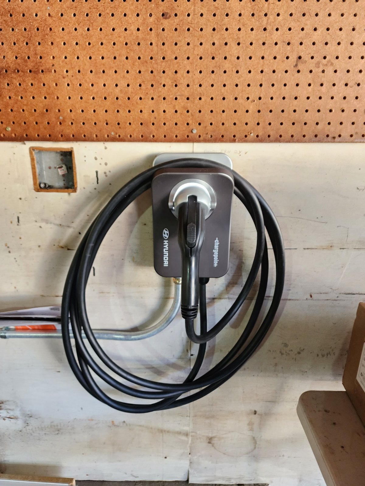 EV charger coiled cable, installed by Wolf River Electric