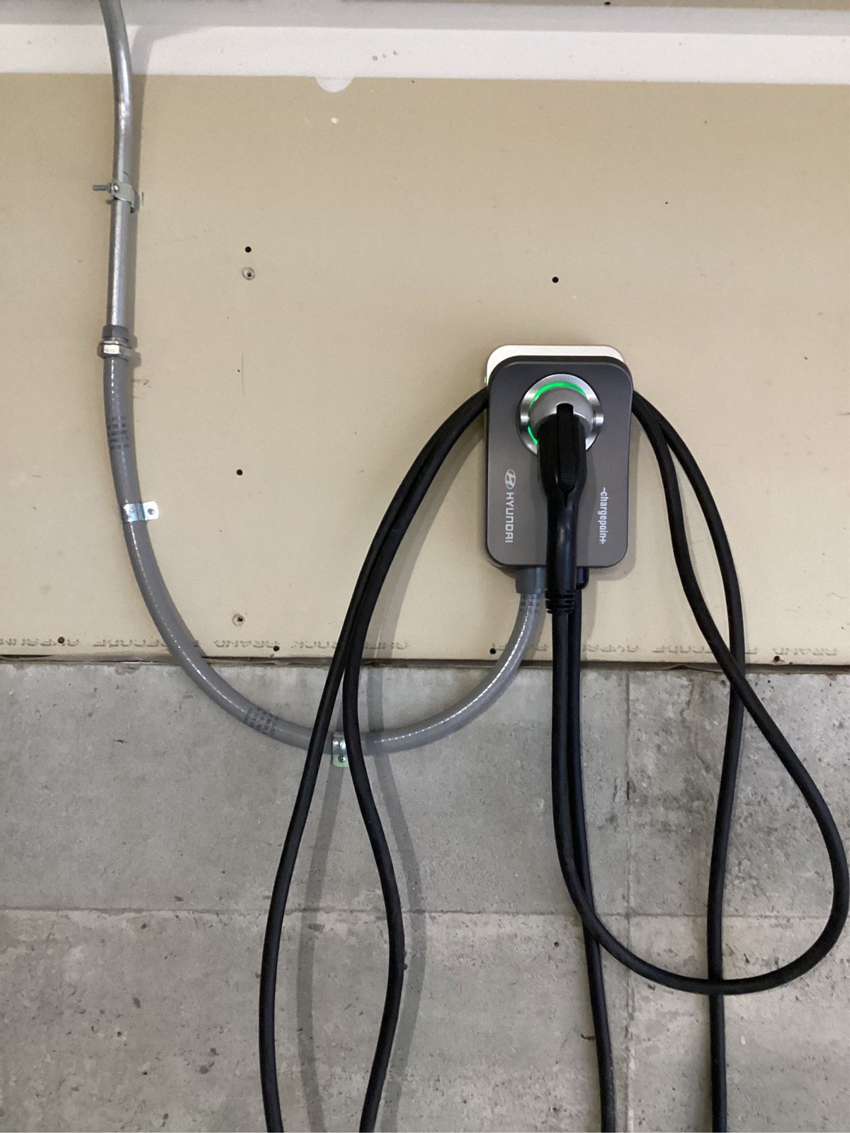 Level 2 EV charger mounted on a garage wall, installed by Wolf River Electric