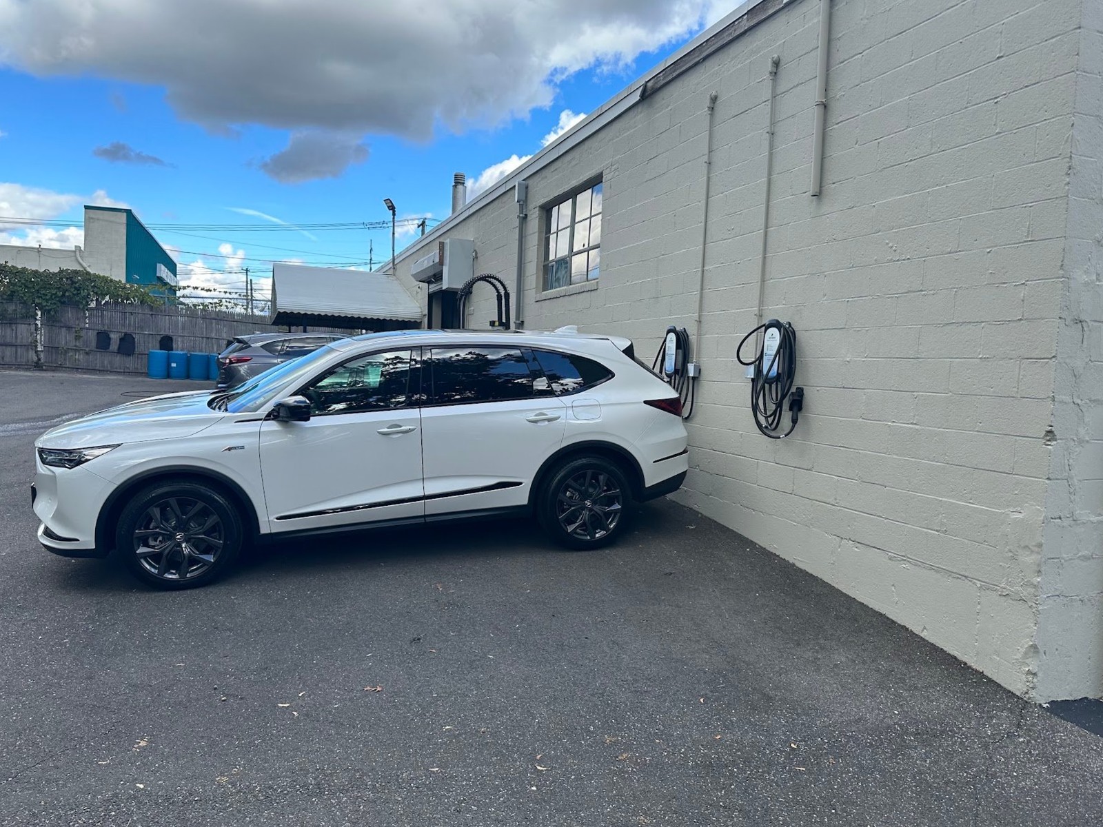 EV charging lot white car, installed by Wolf River Electric
