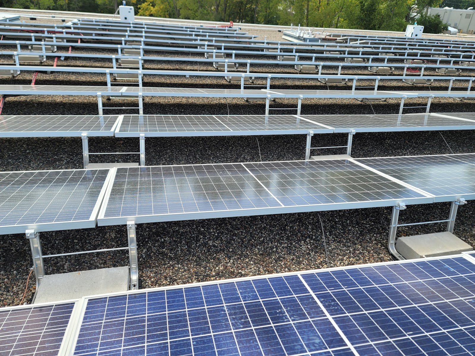 Flat roof rows close solar, installed by Wolf River Electric