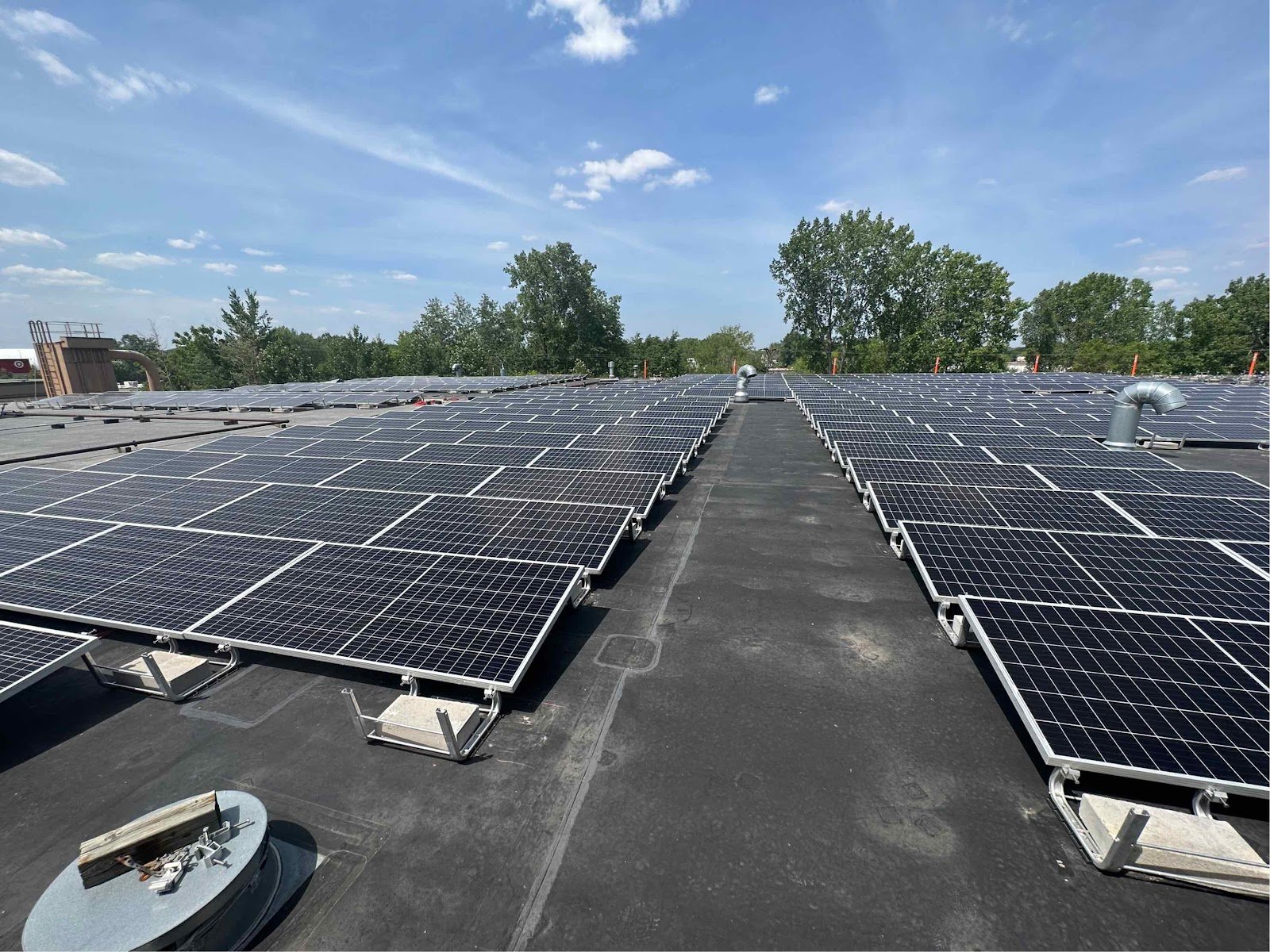Commercial flat roof solar array with a center walkway, installed by Wolf River Electric