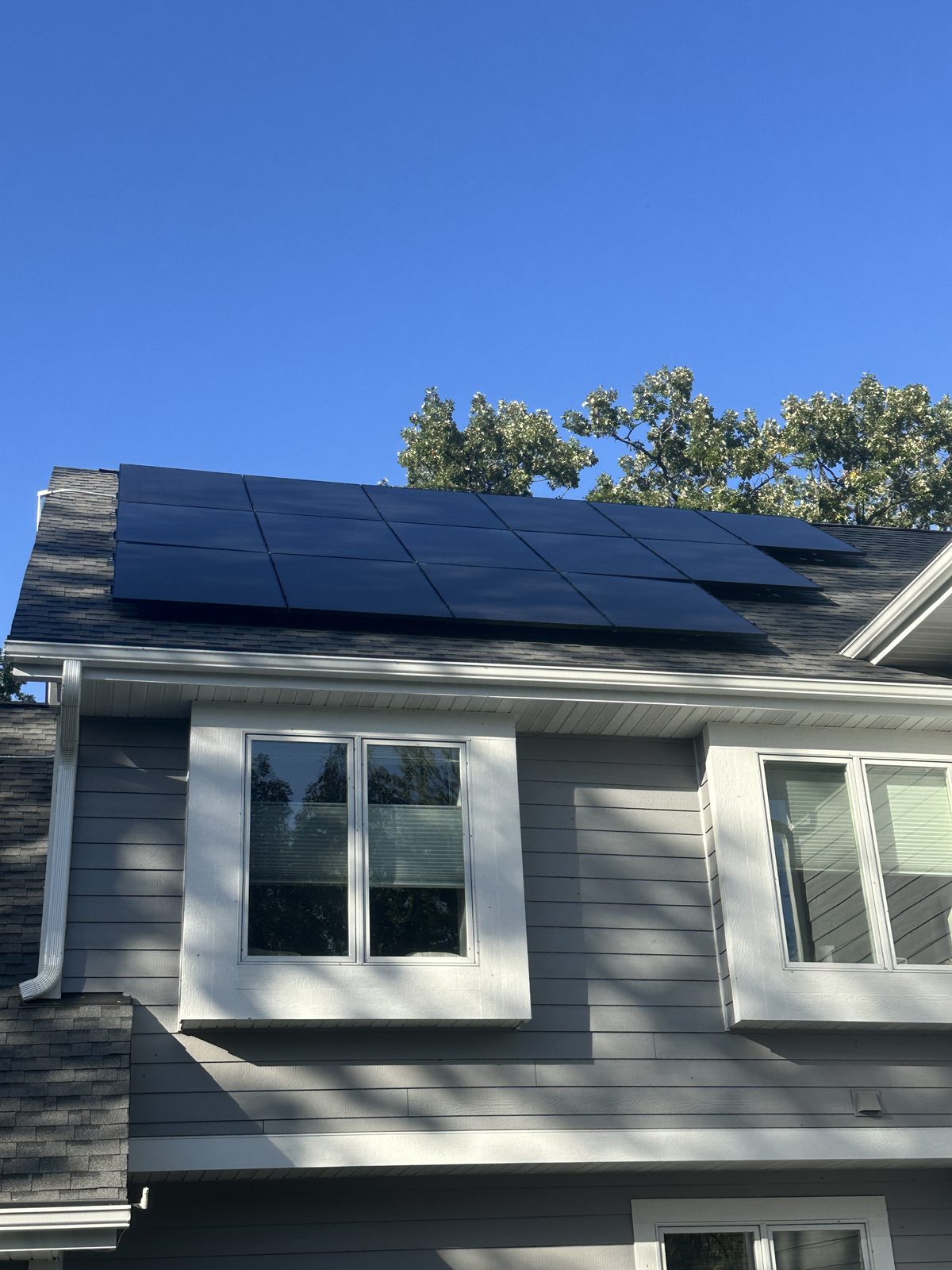 Gray home with black solar, installed by Wolf River Electric