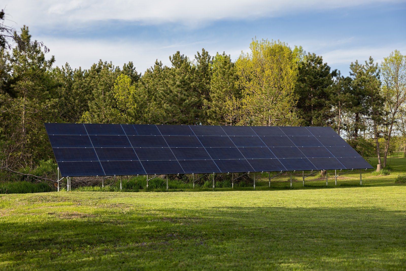 Ground-mount solar array distant, installed by Wolf River Electric