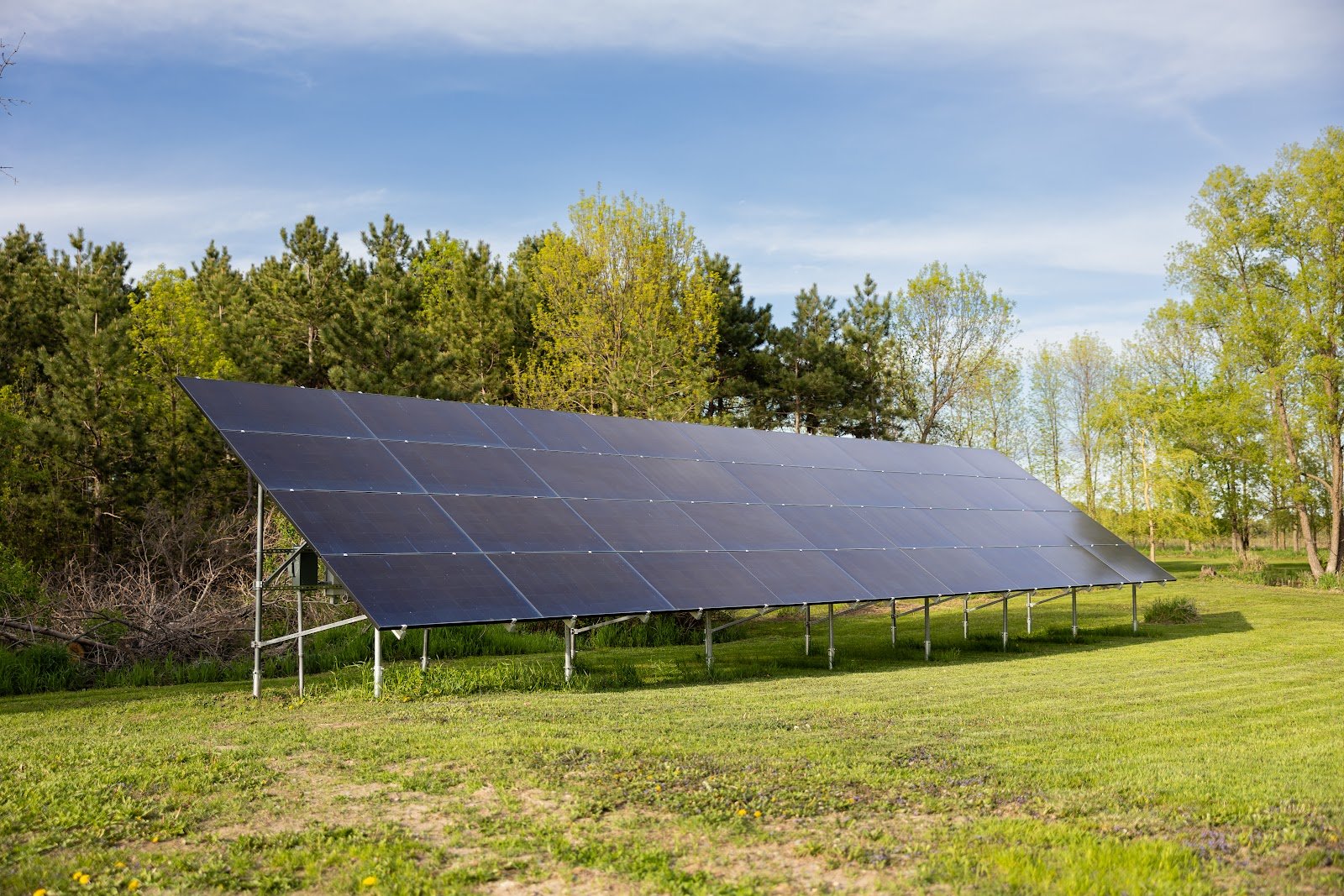 Ground-mount solar array spring, installed by Wolf River Electric