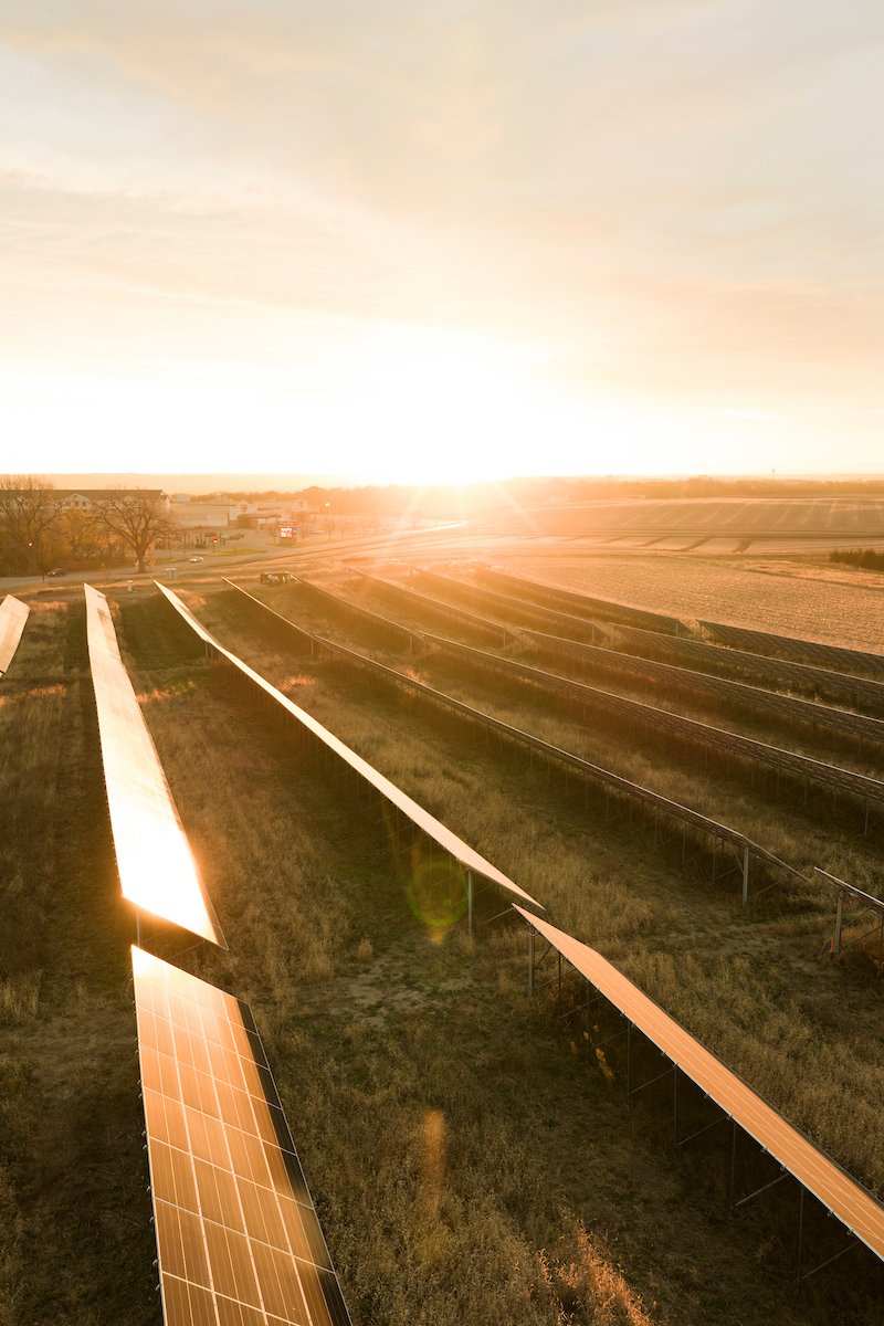 Sunset over ground-mount solar rows, installed by Wolf River Electric