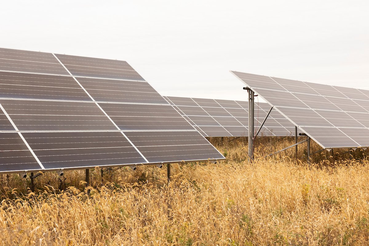 Ground-mount solar tables in a prairie field, installed by Wolf River Electric